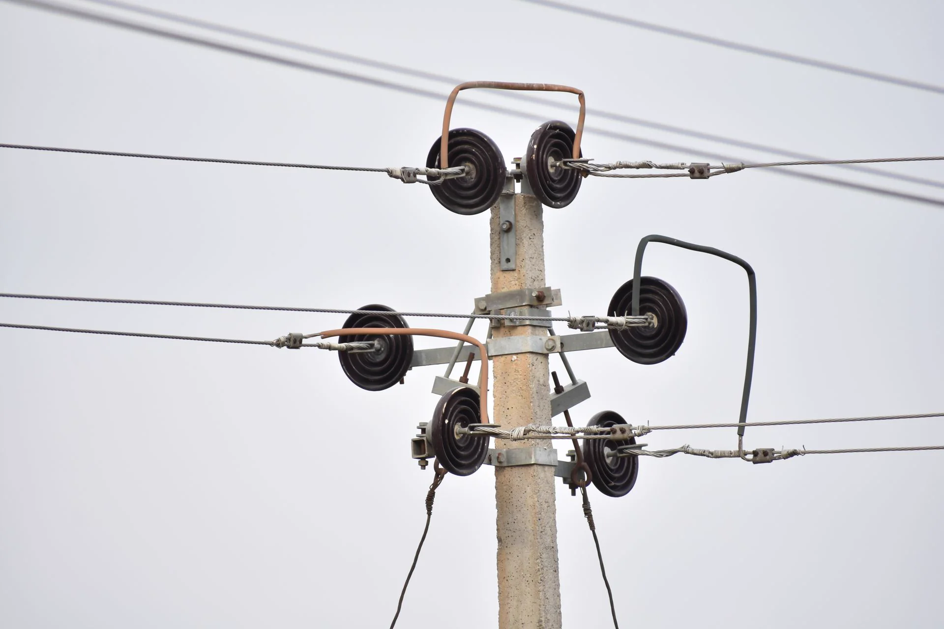 Utility pole cross-arm with conductors, representative of the OEB regulatory hearing over transmission-line liability