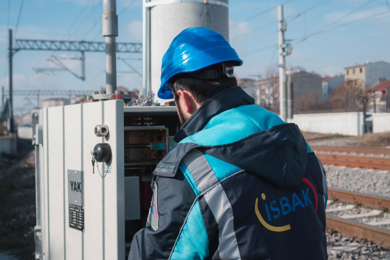 Technician inspecting an open electrical panel during a CP system review
