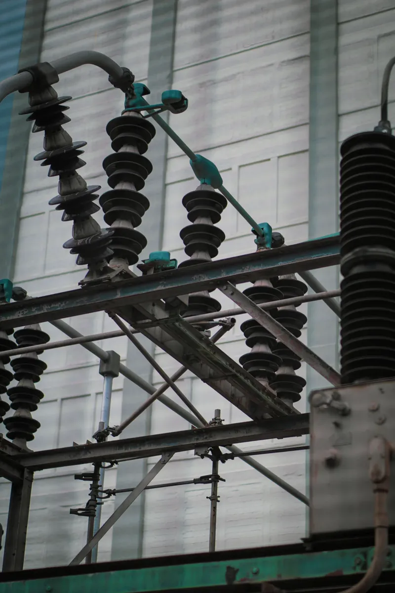 Close-up of transformer hardware and porcelain insulators
