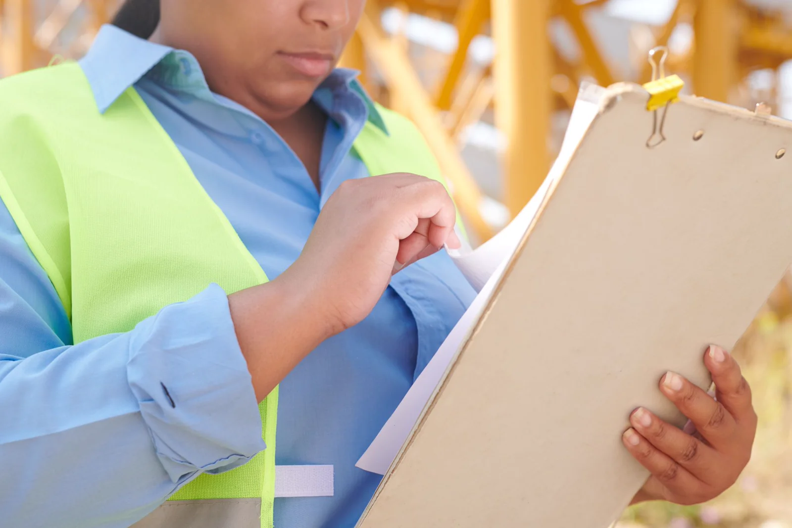 Technician holding a clipboard reviewing field findings on site