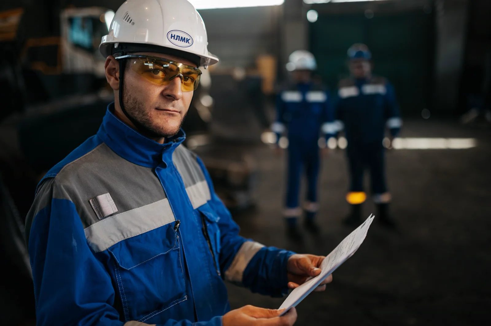 Inspector reviewing coating specification documents at a plant