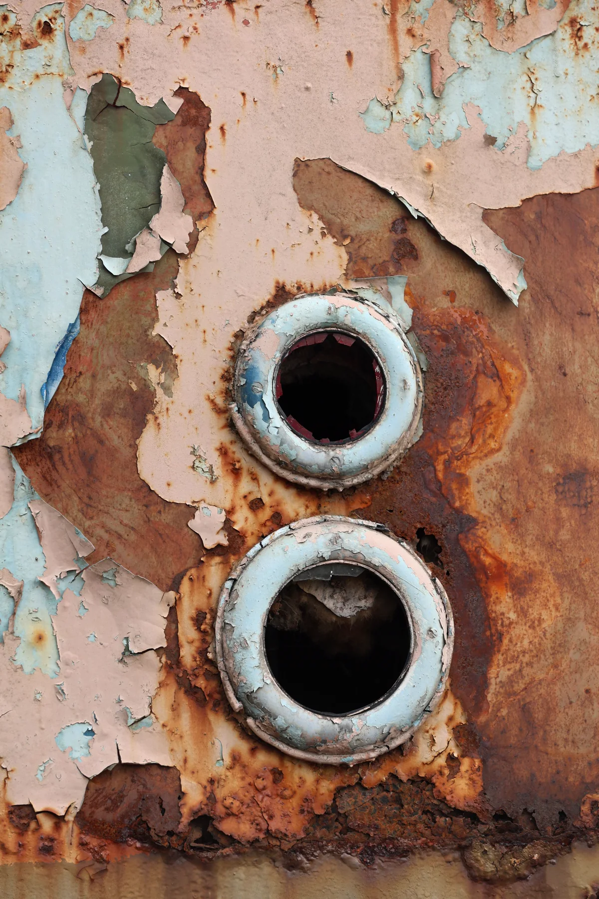 Macro shot of a corroding metal surface with peeling paint