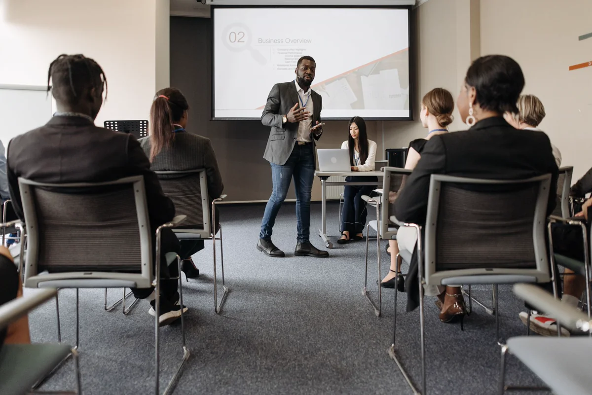 Presenter addressing a seated group at a technical conference